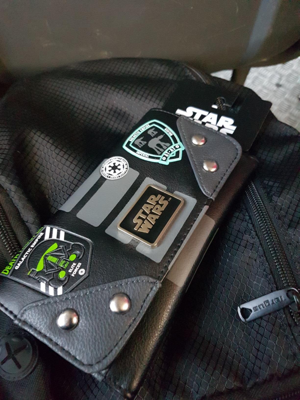 Happy customer displaying their Star Wars Rogue One Empire wallet in use.