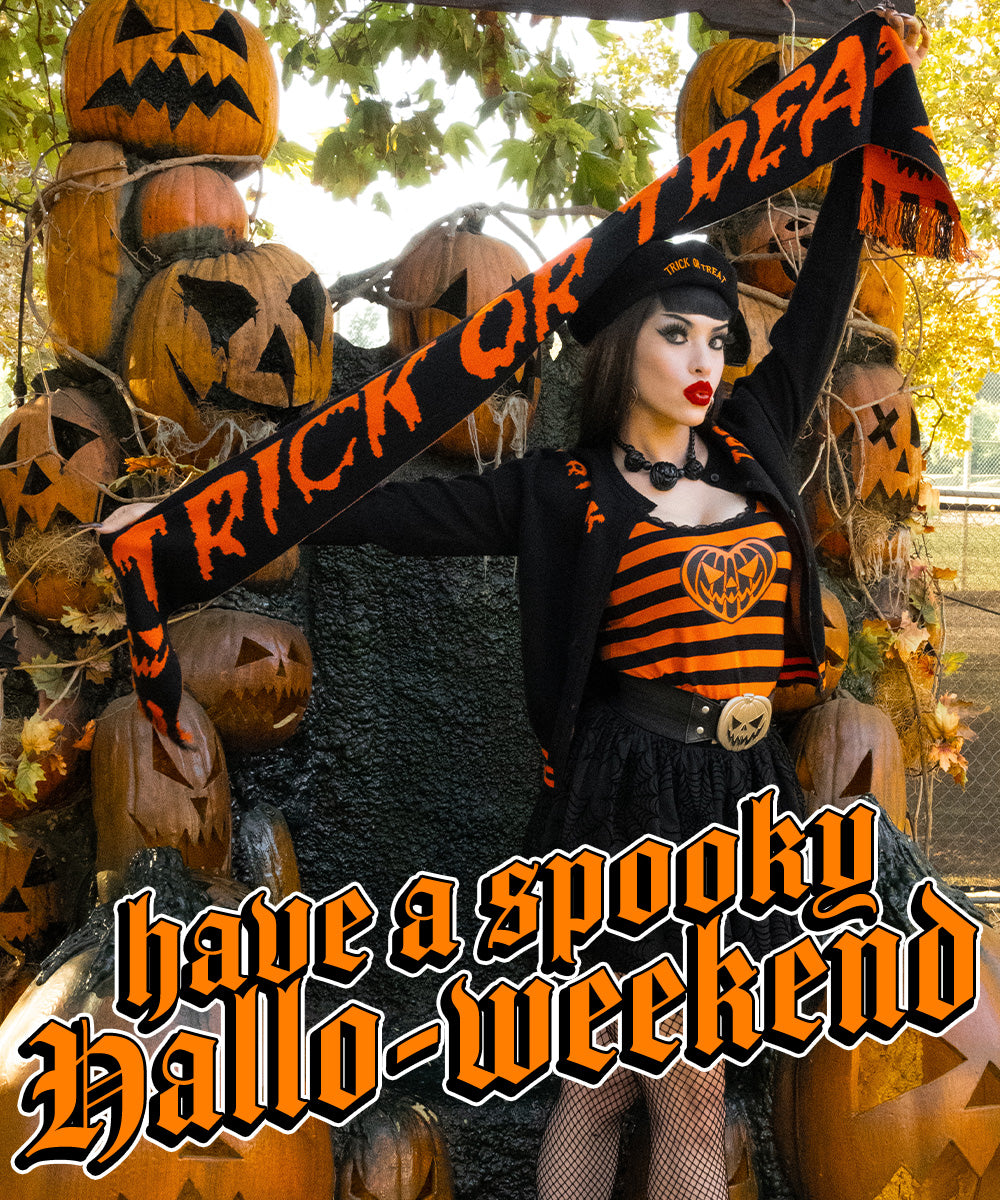Model wearing the pumpkin waist belt with a black-and-orange outfit, holding a Trick or Treat scarf among jack-o’-lanterns.
