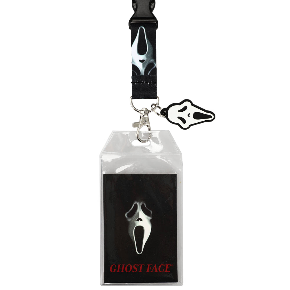 Official Scream Ghost Face themed lanyard and ID badge holder set, featuring a black strap with a silver and black Ghost Face mask print, a silver clasp, a small black-and-white Ghost Face charm, and a clear plastic badge pouch over a black card printed with the Ghost Face mask and red text.